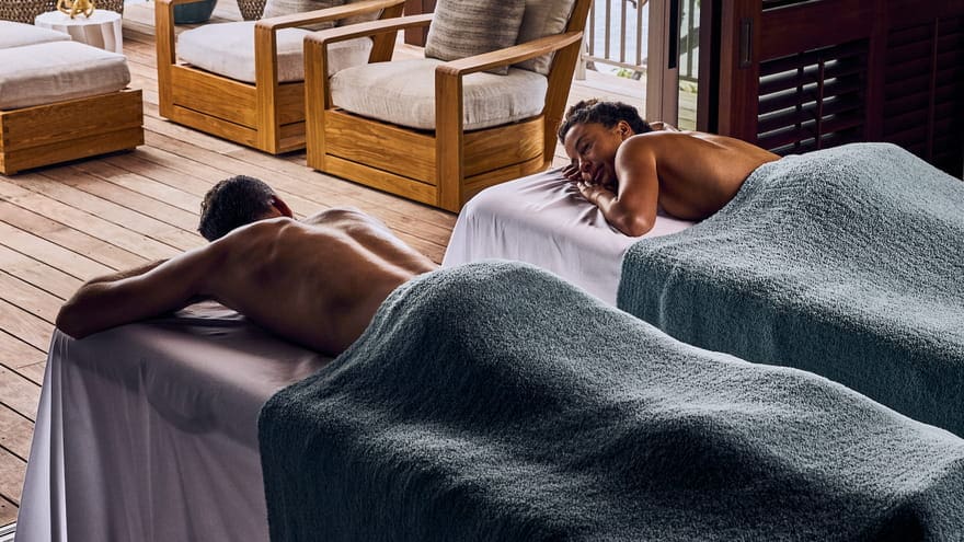 a man and woman lying on beds