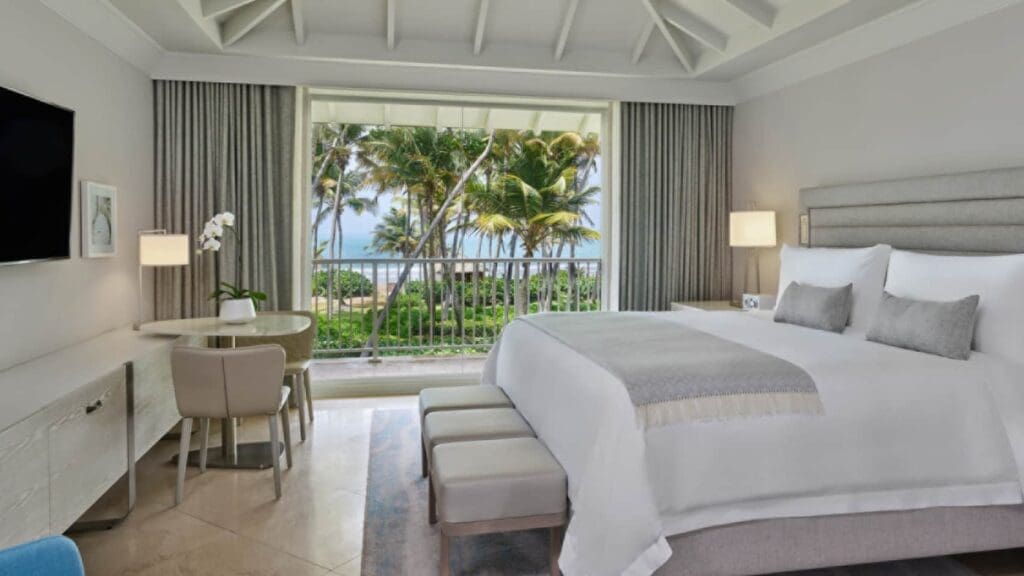 a room with a bed and chairs and a table and chairs