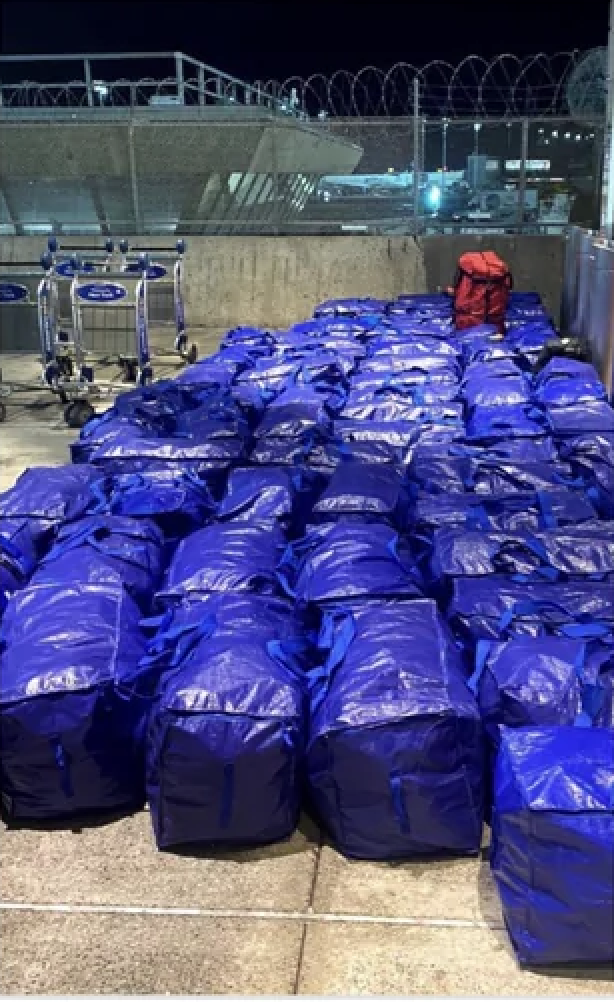 a large pile of blue bags