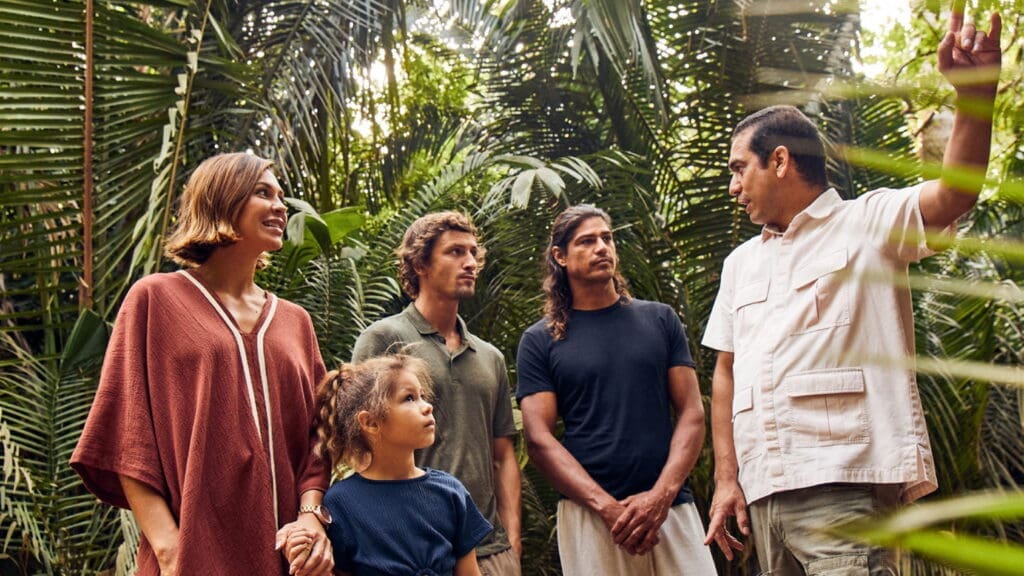 a group of people standing in a forest
