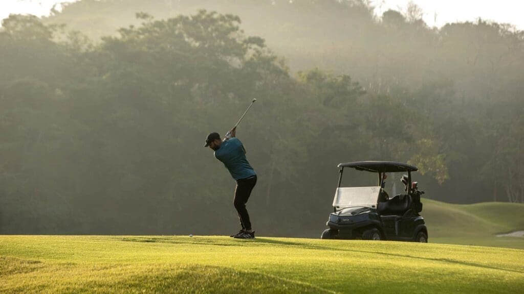 a man swinging a golf club