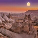 a moon over a valley