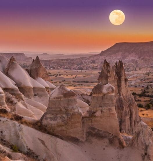 a moon over a valley