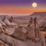 a moon over a valley