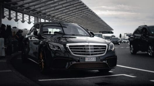a black car mercedes parked at the airport