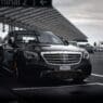 a black car mercedes parked at the airport