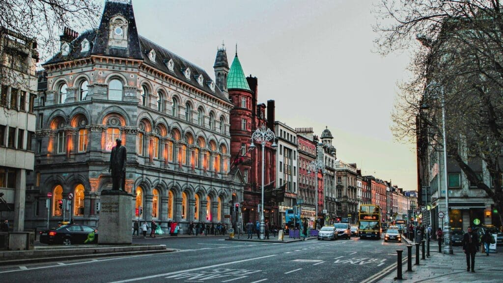 a street with a statue and buildings