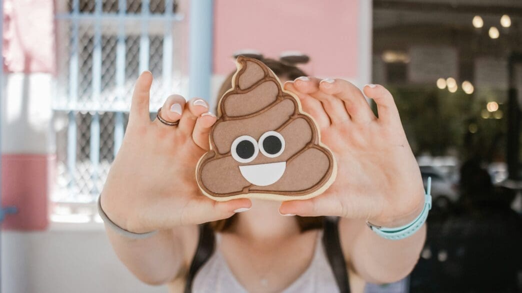 a person holding a poop cookie