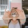 a person holding a poop cookie