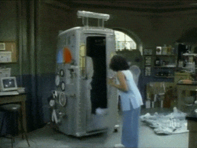a woman standing in front of a large metal object