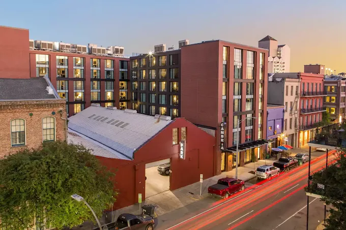 a building with cars parked on the side of the road