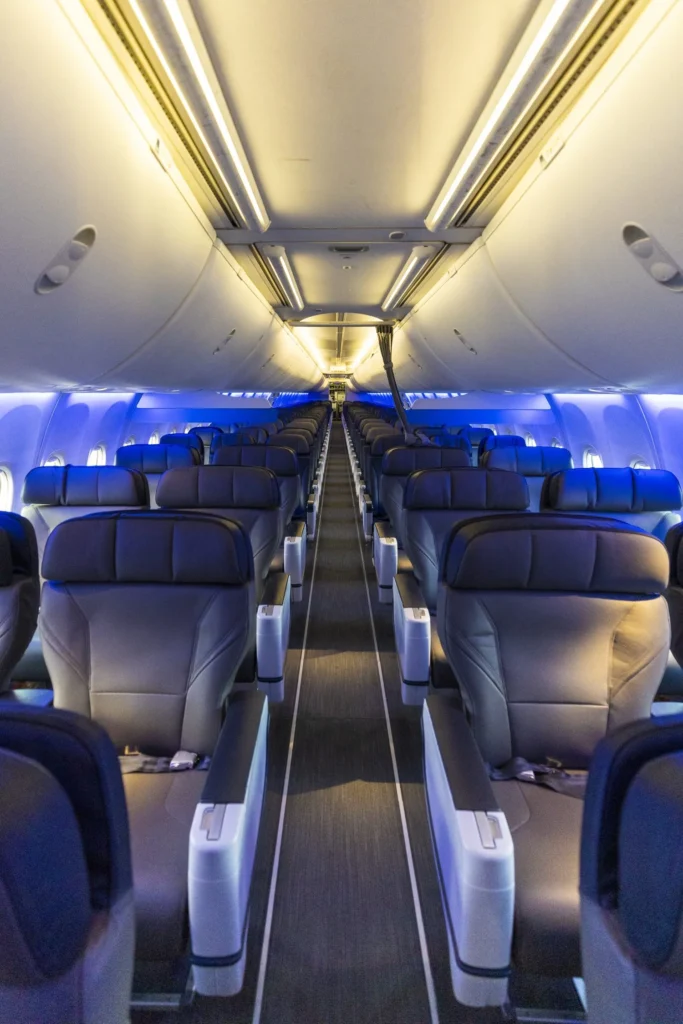 the inside of an airplane with rows of seats