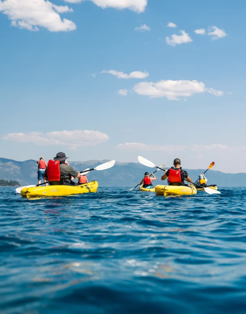 a group of people in kayaks on a lake