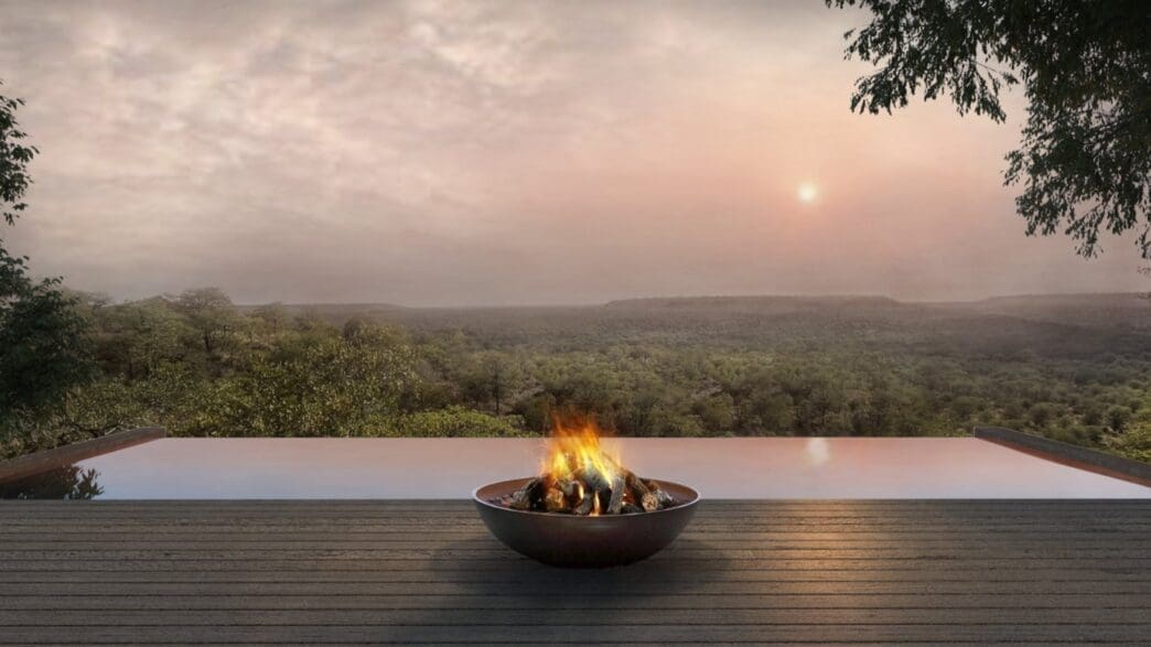 a fire pit on a deck overlooking a river