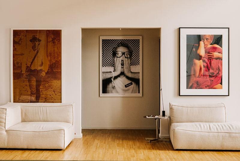 a room with couches and pictures on the wall
