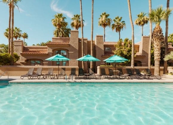 a pool with umbrellas and chairs
