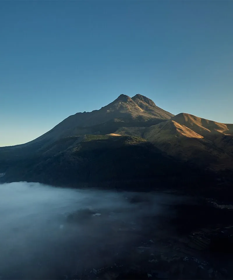 a mountain with a blue sky