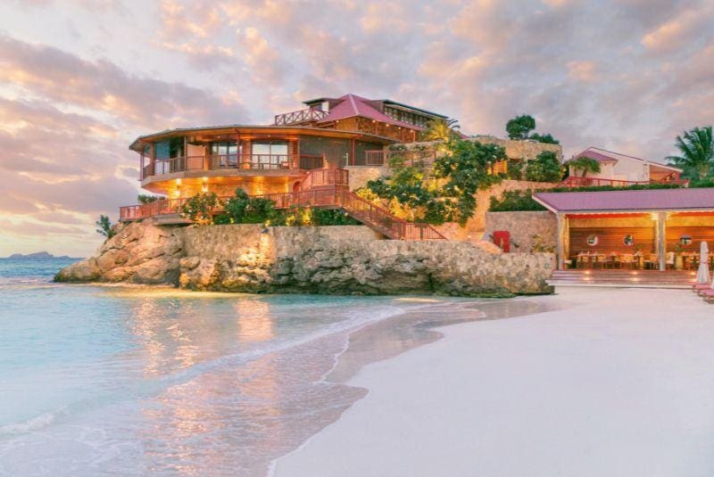 a house on a cliff by the water