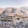 a group of houses in a snowy landscape