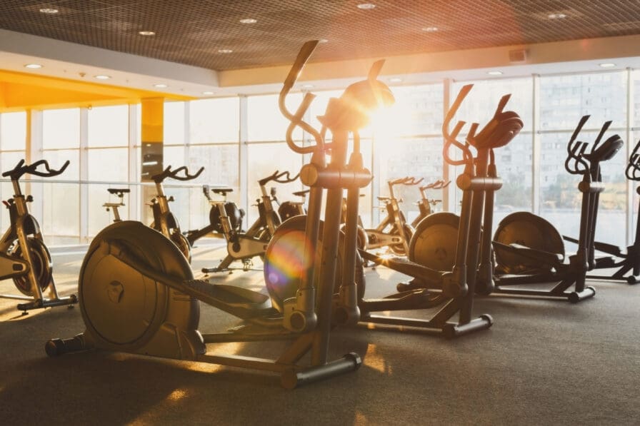 a group of exercise bikes in a gym