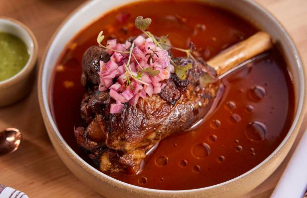 a bowl of soup with a wooden stick on top