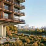a building with a river and trees