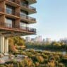 a building with a river and trees