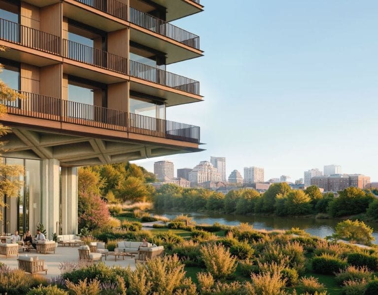 a building with a river and trees