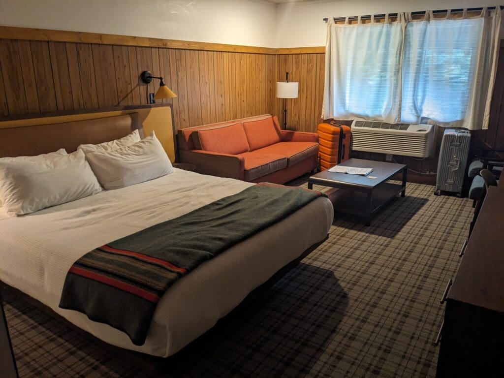 a room with a bed and couches