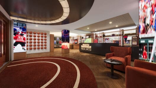 a sports store with a red rug and a red chair
