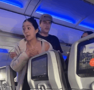 a woman standing in a plane