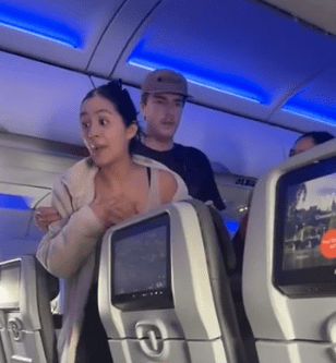 a woman standing in a plane