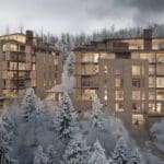 a group of buildings with snow covered trees
