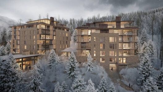 a group of buildings with snow covered trees