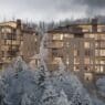 a group of buildings with snow covered trees