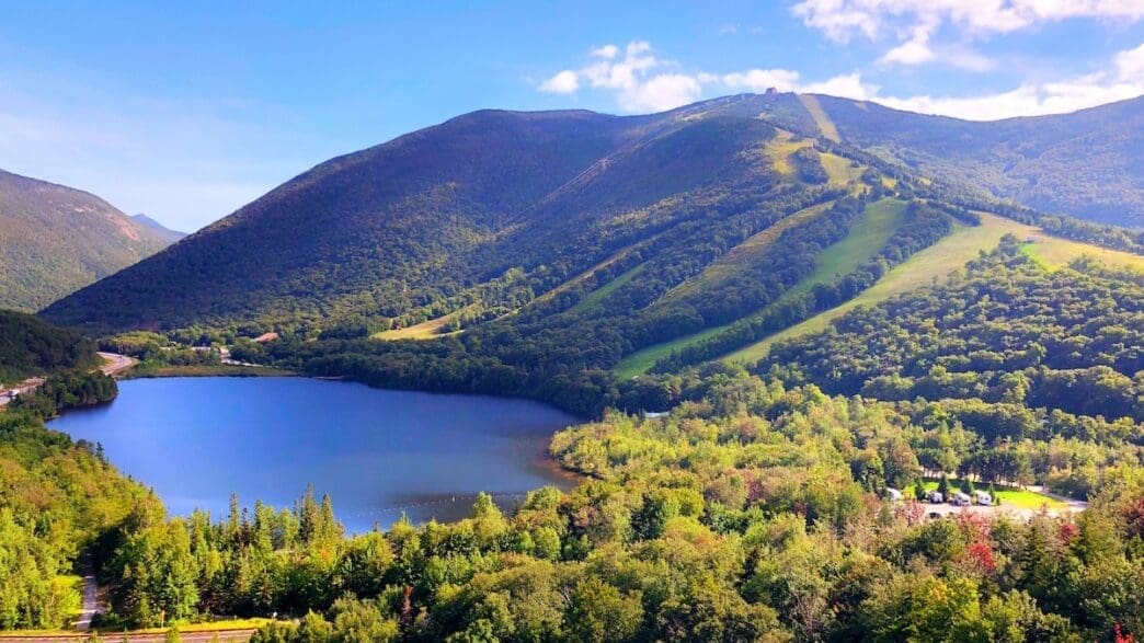 a lake surrounded by trees and mountains
