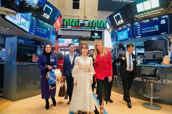 a group of people standing in front of digital screens