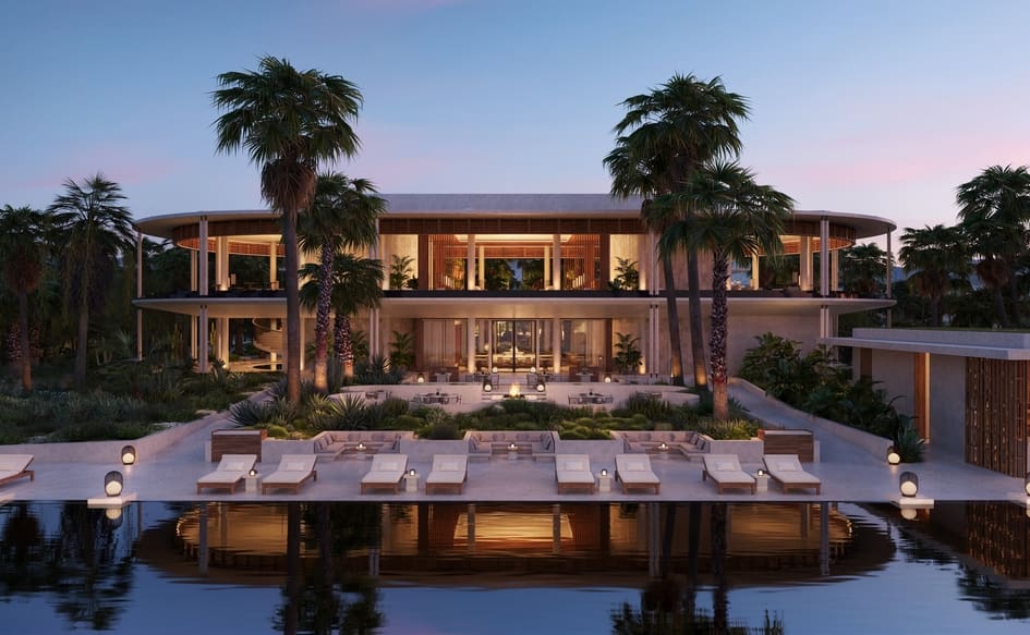 a large building with palm trees and a pool