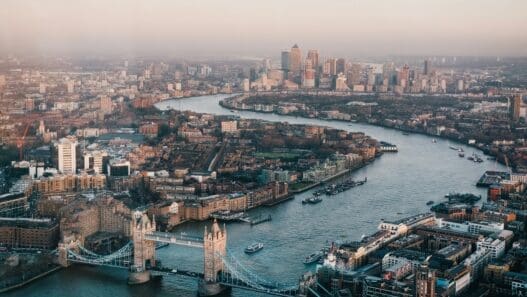 a river with a bridge and a city in the background