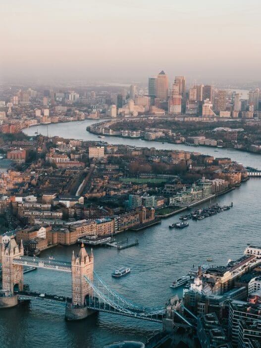 a river with a bridge and a city in the background