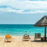 a beach with chairs and umbrellas
