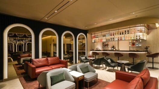 a room with a bar and chairs