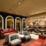 a room with a bar and chairs