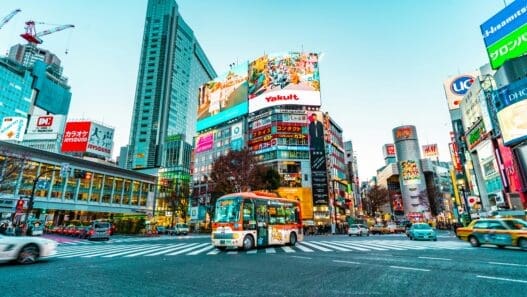 a city street with buildings and a bus