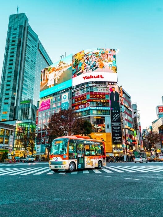 a city street with buildings and a bus