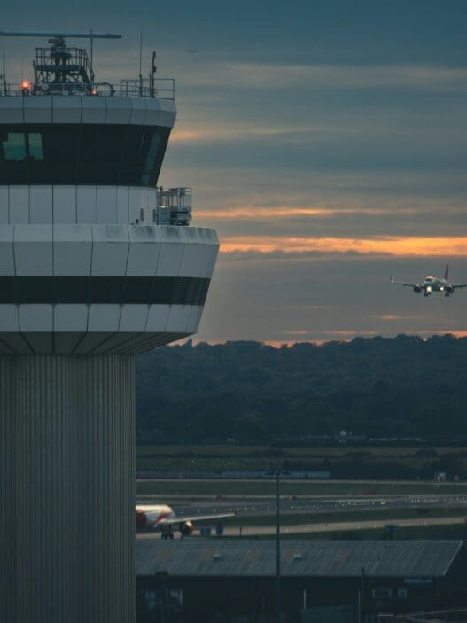 a plane flying over a control tower
