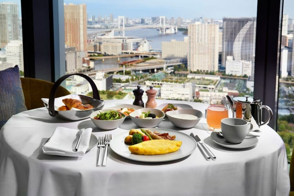 a table with food on it and a view of a city