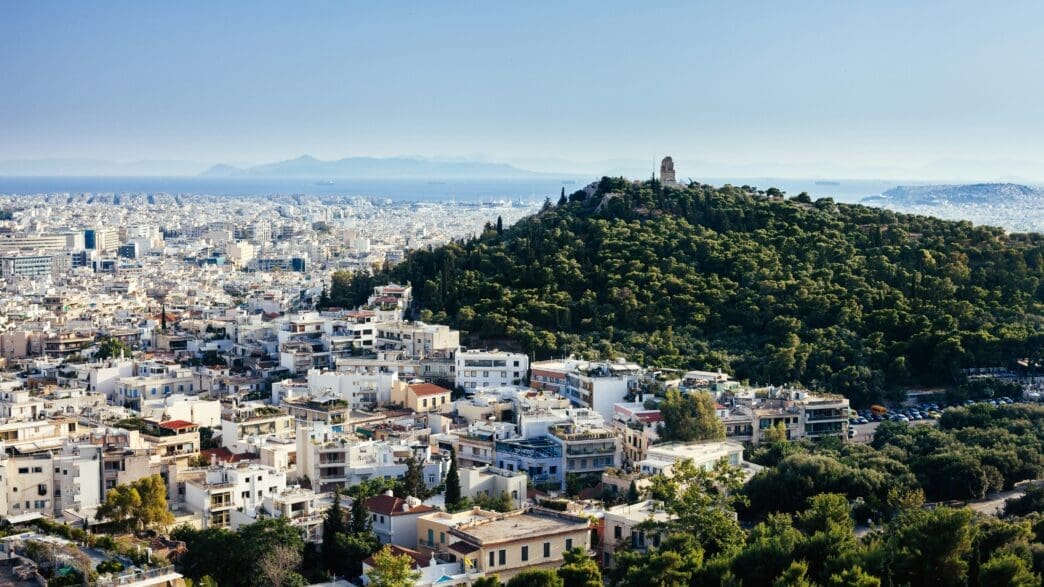 a city with trees and a hill