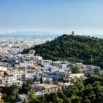 a city with trees and a hill