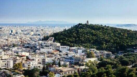 a city with trees and a hill